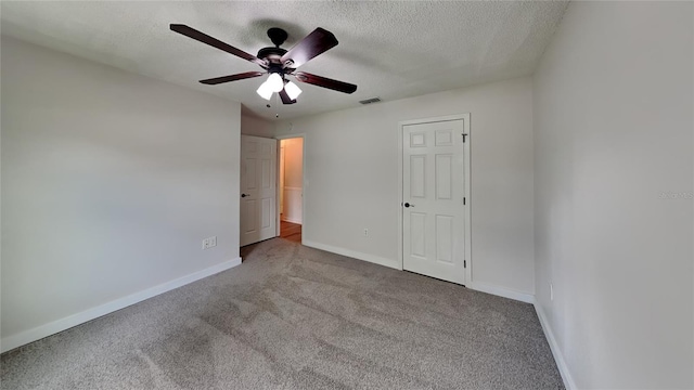 unfurnished bedroom featuring a textured ceiling, carpet, and ceiling fan