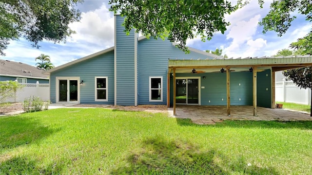 back of house featuring a patio area, a lawn, and ceiling fan