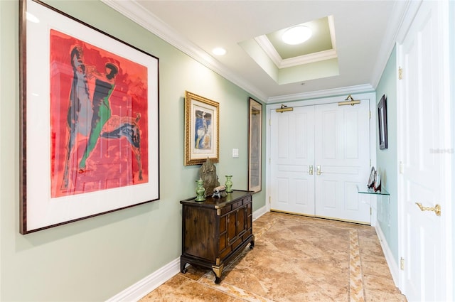 corridor featuring crown molding and a tray ceiling