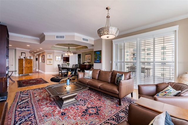 living room with ornamental molding and light wood-type flooring