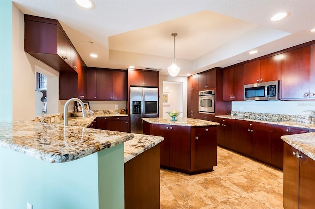 kitchen featuring a kitchen island, hanging light fixtures, stainless steel appliances, sink, and light stone counters