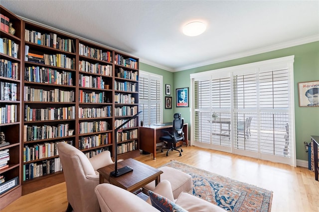 home office with ornamental molding and light wood-type flooring