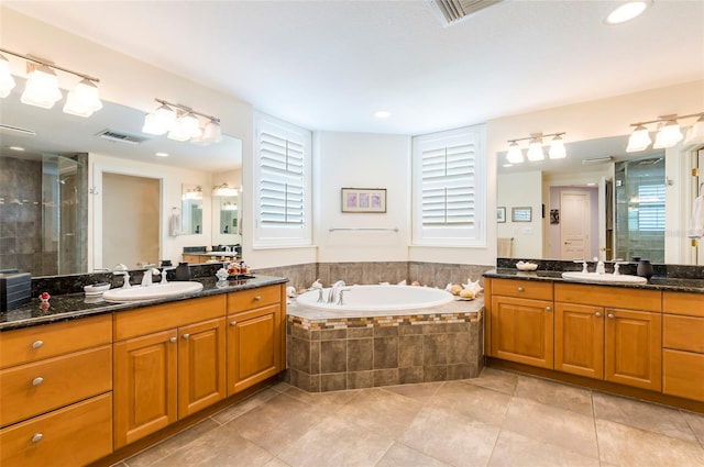 bathroom with vanity, plus walk in shower, and tile patterned floors