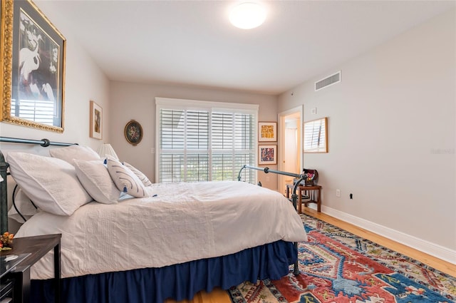 bedroom with hardwood / wood-style flooring