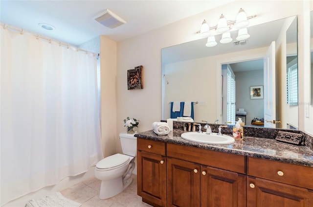 bathroom with toilet, a shower with curtain, vanity, and tile patterned floors