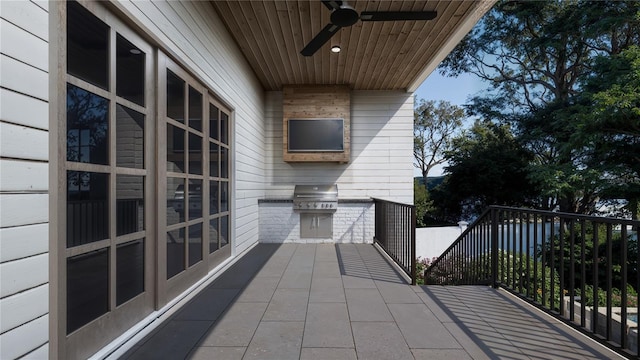 balcony with grilling area, ceiling fan, and exterior kitchen