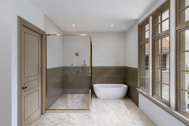 bathroom featuring tile walls, tile patterned floors, and plus walk in shower