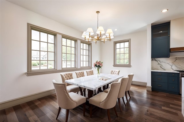 dining room with dark wood-type flooring and a notable chandelier