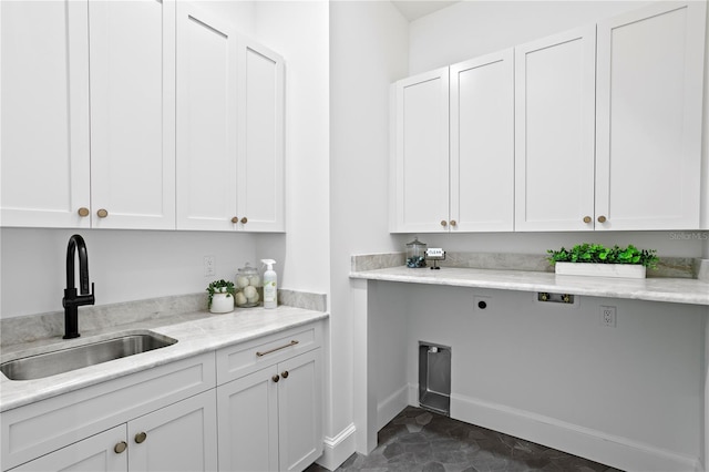 4633 W Lowell Ave, Tampa, FL 33629 - laundry area featuring cabinet space, hookup for an electric dryer, and baseboards