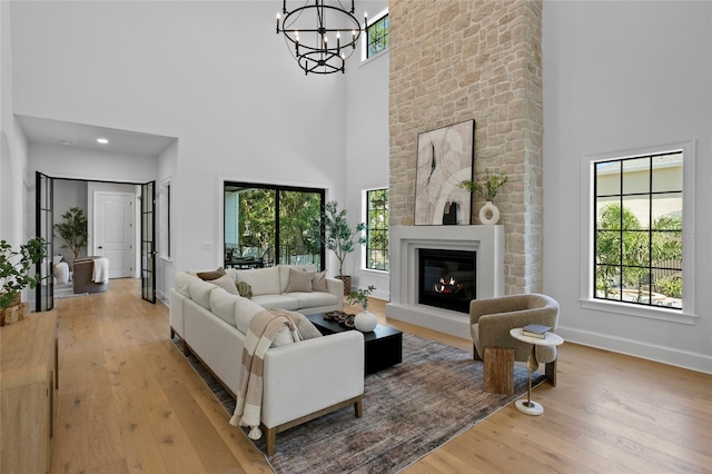 4633 W Lowell Ave, Tampa, FL 33629 - living area with a high ceiling, hardwood / wood-style flooring, a chandelier, a large fireplace, and baseboards