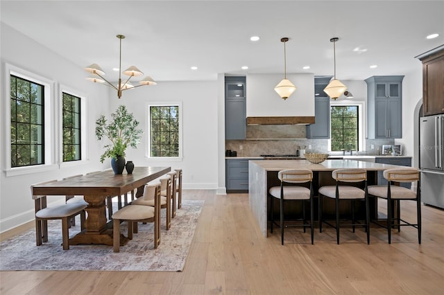 4633 W Lowell Ave, Tampa, FL 33629 - dining space featuring baseboards, light wood-style floors, recessed lighting, and a chandelier
