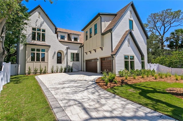 4633 W Lowell Ave, Tampa, FL 33629 - tudor home featuring decorative driveway, a garage, stucco siding, board and batten siding, and roof with shingles