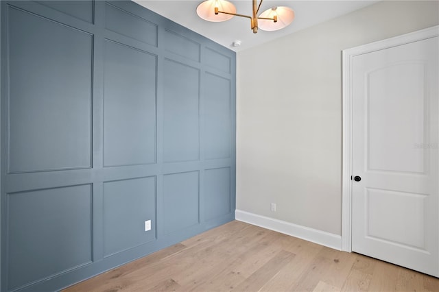 4633 W Lowell Ave, Tampa, FL 33629 - unfurnished bedroom featuring a chandelier, baseboards, light wood-style floors, and a closet