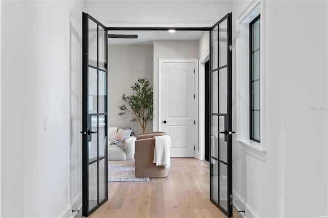 4633 W Lowell Ave, Tampa, FL 33629 - hall featuring french doors, light wood finished floors, and baseboards