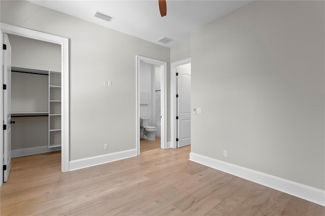 4633 W Lowell Ave, Tampa, FL 33629 - unfurnished bedroom featuring a spacious closet, baseboards, light wood finished floors, and a closet