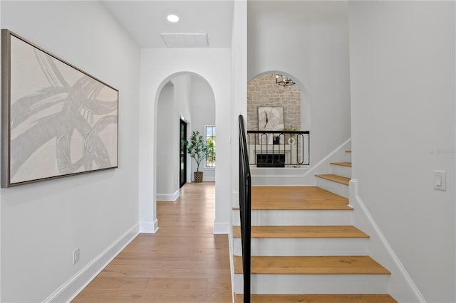 4633 W Lowell Ave, Tampa, FL 33629 - stairway with wood finished floors, baseboards, and arched walkways