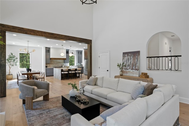 4633 W Lowell Ave, Tampa, FL 33629 - living area featuring a chandelier, light wood finished floors, recessed lighting, a towering ceiling, and baseboards