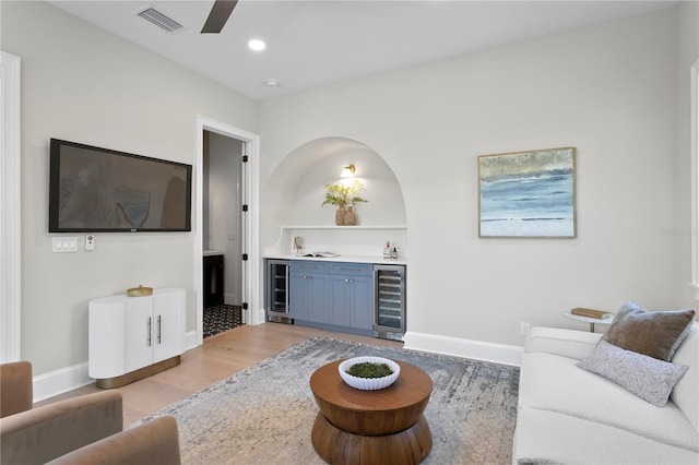 4633 W Lowell Ave, Tampa, FL 33629 - living room featuring wine cooler, bar with sink, a ceiling fan, baseboards, and recessed lighting