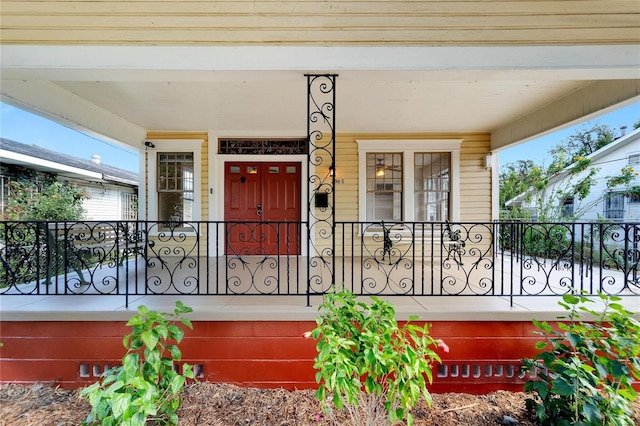 view of exterior entry featuring a porch