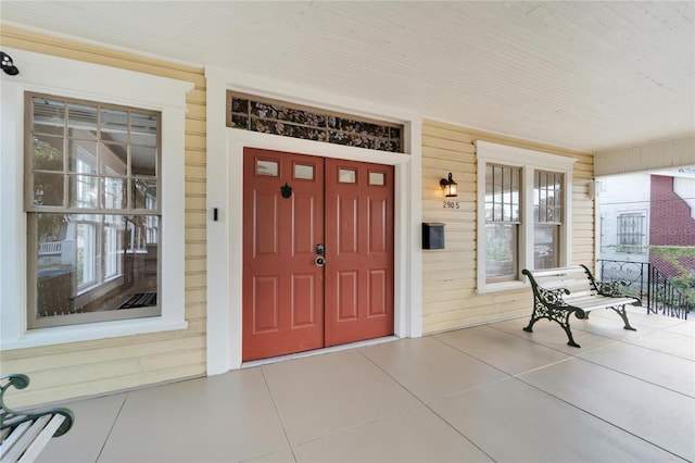 view of exterior entry featuring a porch