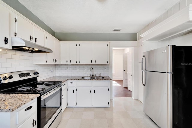 kitchen featuring under cabinet range hood, white cabinetry, appliances with stainless steel finishes, and a sink