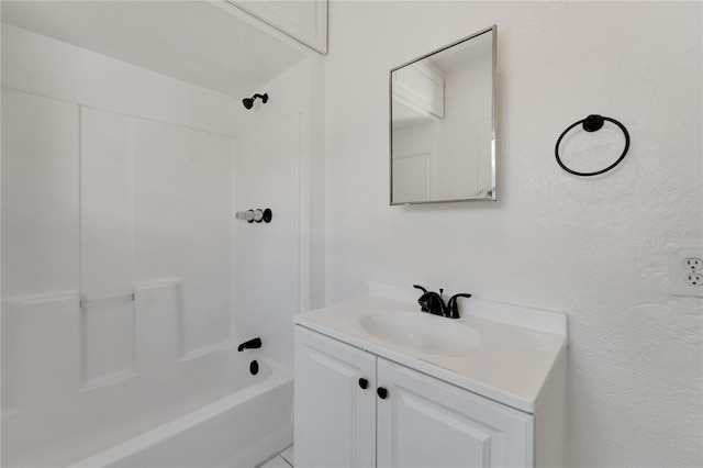 bathroom featuring washtub / shower combination and vanity