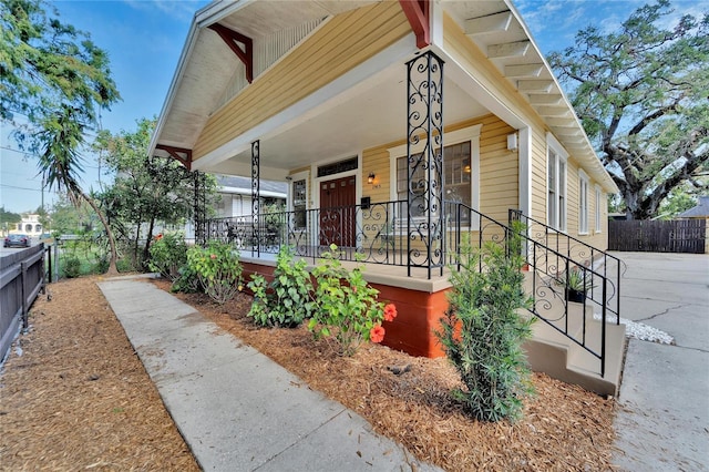 exterior space with a porch and fence