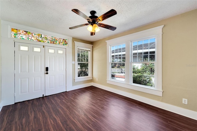 foyer featuring a textured ceiling, dark wood-style flooring, a ceiling fan, and baseboards