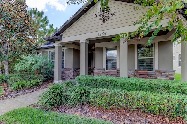 view of exterior entry with covered porch