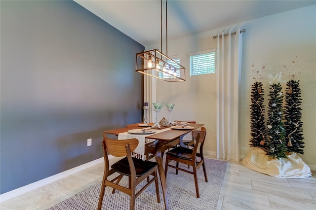 dining area with an inviting chandelier