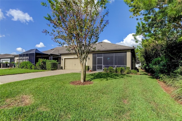 view of front of home with a garage and a front lawn