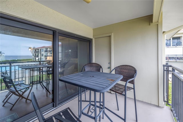 balcony featuring a water view