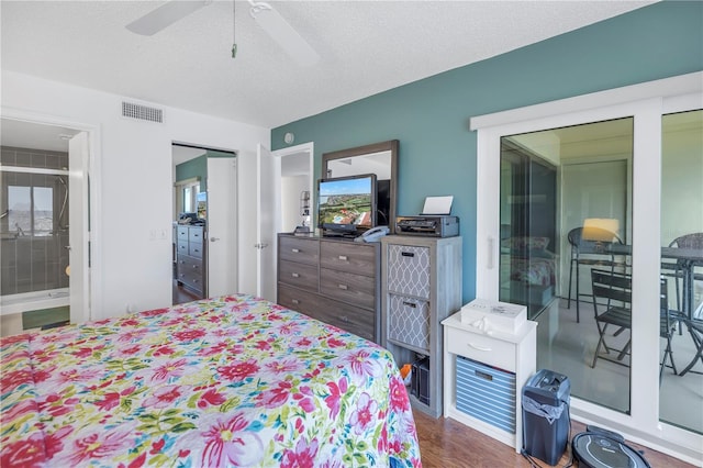 bedroom with hardwood / wood-style floors, ceiling fan, and a textured ceiling