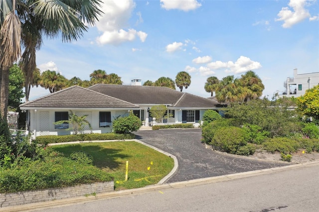 5031 W San Miguel St, Tampa, FL 33629 - ranch-style house featuring a tile roof, asphalt driveway, a chimney, a front yard, and stucco siding