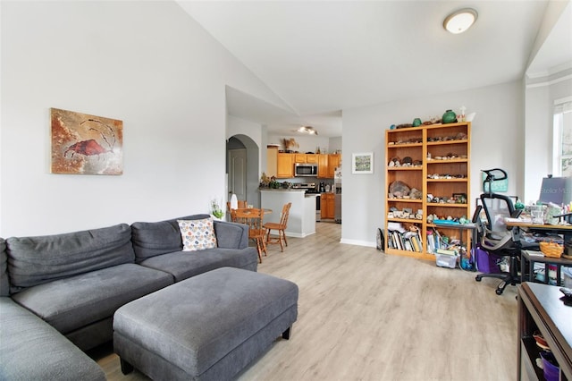 living room featuring light hardwood / wood-style flooring and vaulted ceiling