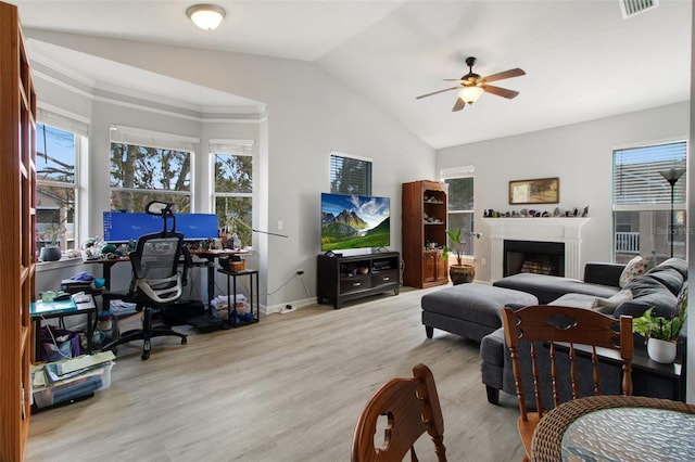 living room featuring light hardwood / wood-style floors, ceiling fan, and vaulted ceiling