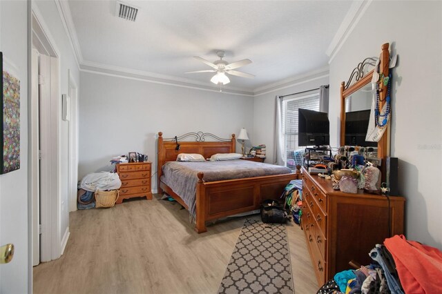 bedroom with ornamental molding, light wood-type flooring, and ceiling fan