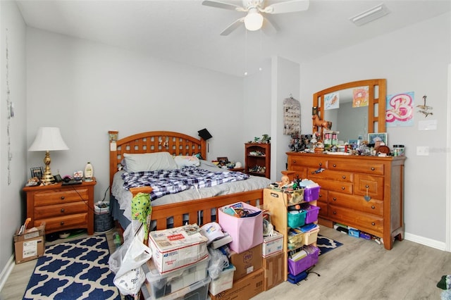 bedroom with light hardwood / wood-style floors and ceiling fan