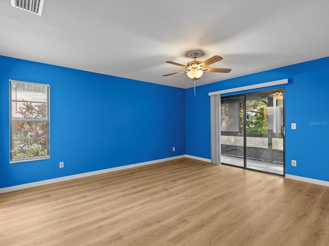 spare room featuring ceiling fan and light hardwood / wood-style flooring