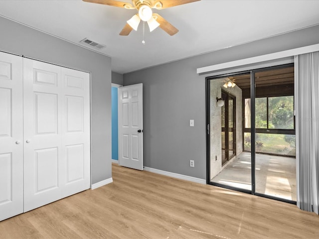 unfurnished bedroom featuring ceiling fan, access to exterior, light wood-type flooring, and a closet