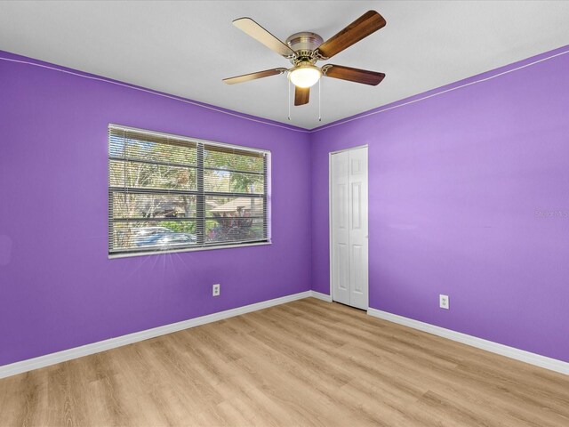 unfurnished room featuring light wood-type flooring and ceiling fan