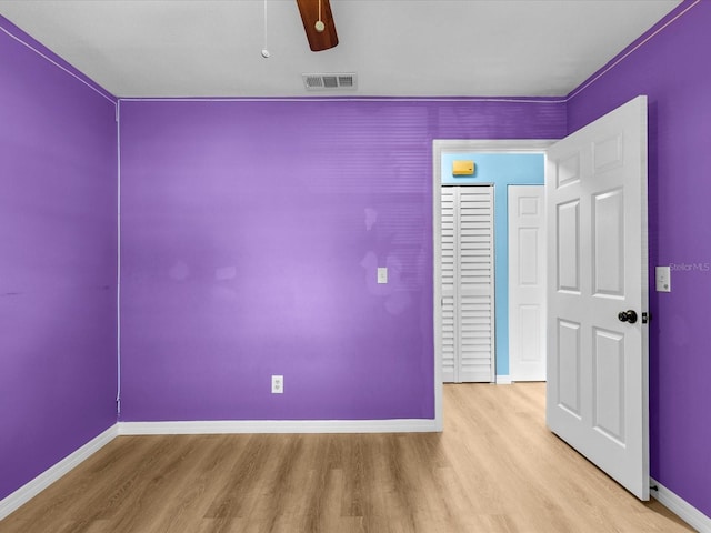 empty room featuring ceiling fan and light wood-type flooring