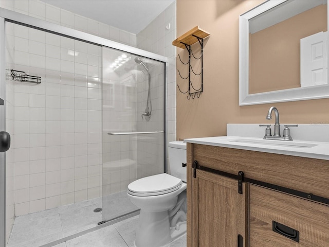 bathroom with tile patterned flooring, vanity, toilet, and a shower with shower door