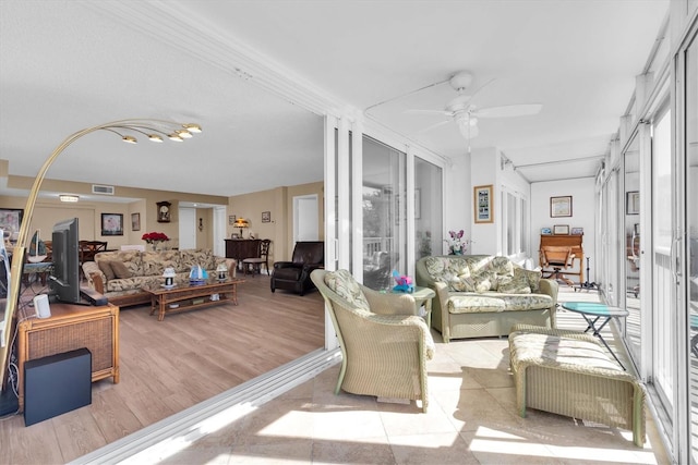 living room featuring ceiling fan and light wood-type flooring