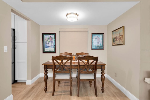 dining space featuring light wood-type flooring