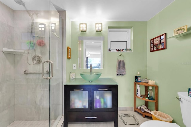 bathroom featuring an enclosed shower, vanity, and toilet