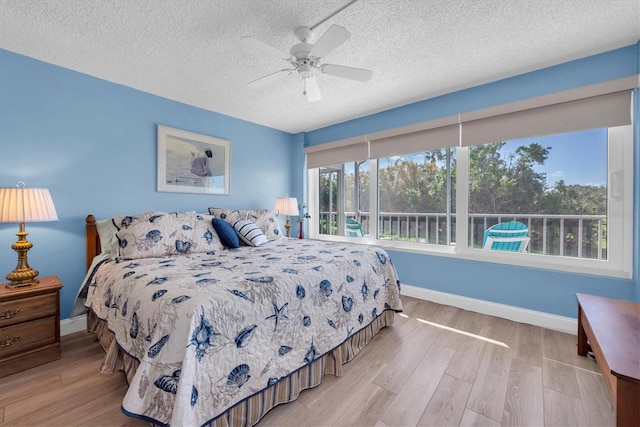 bedroom featuring ceiling fan, a textured ceiling, and light hardwood / wood-style floors