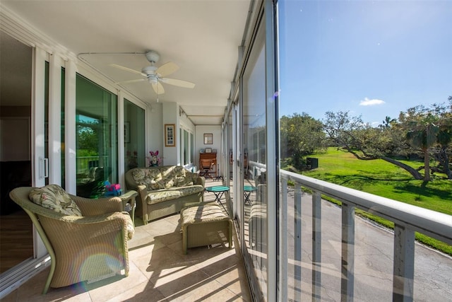 sunroom featuring ceiling fan