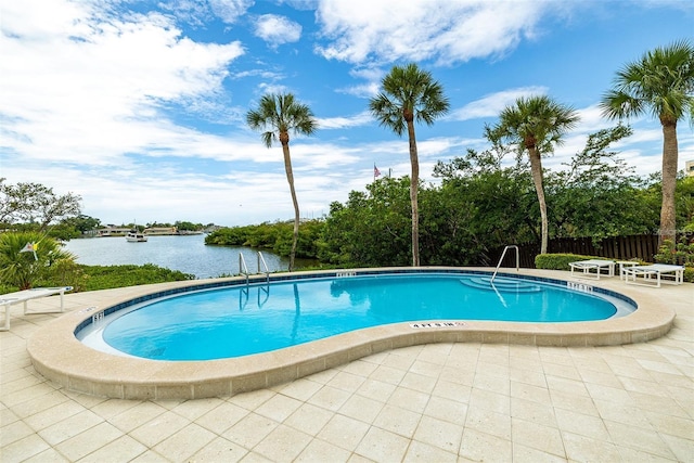 view of pool featuring a patio area and a water view