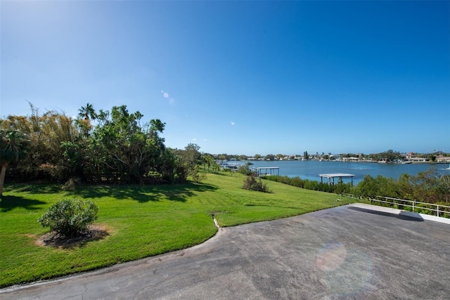 exterior space with a water view and a lawn